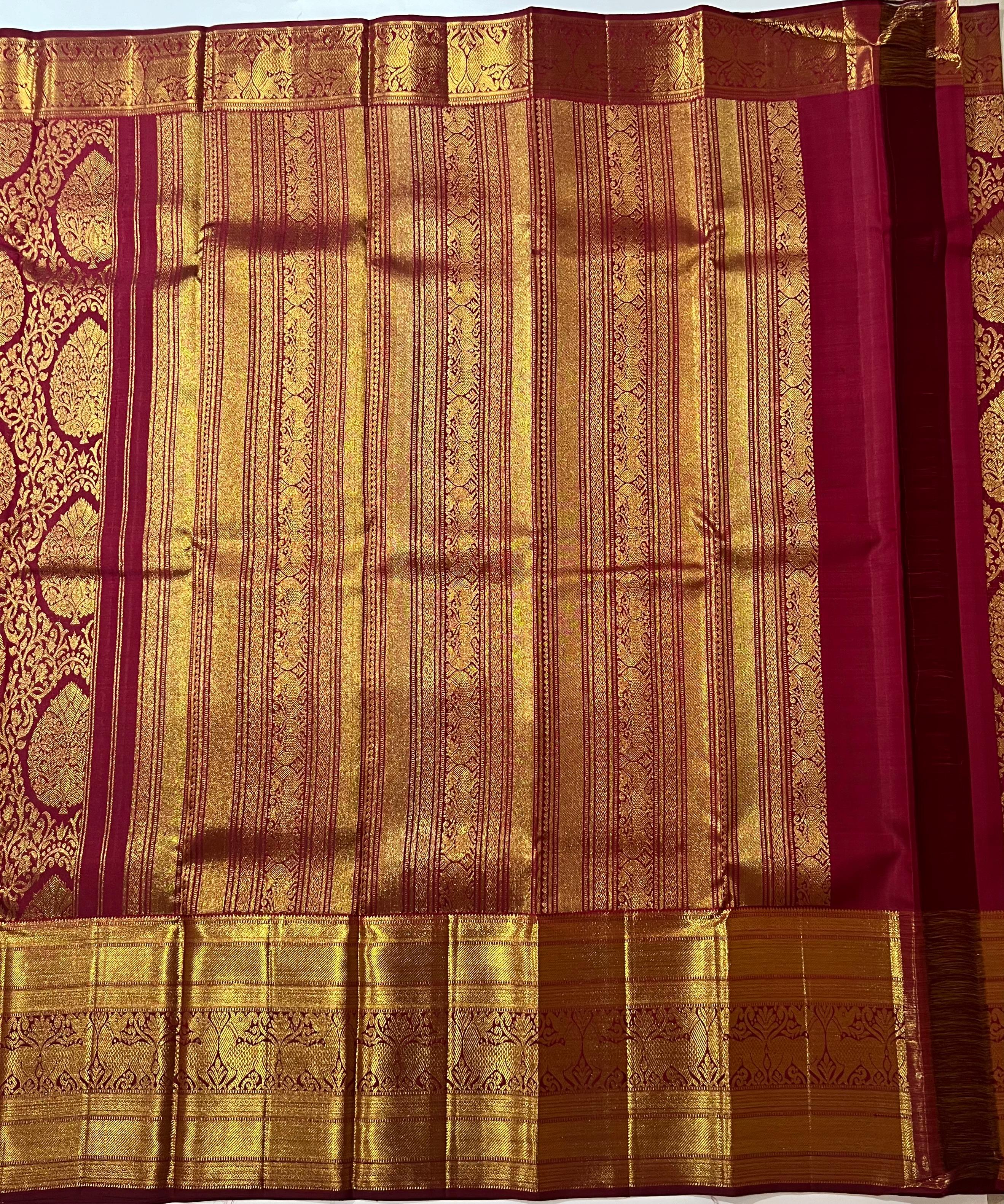 Intricate floral work on maroon and golden Kanjeevaram silk saree